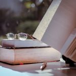 Materials for a Writer Professor: books, paper, pen, glasses, fresh air